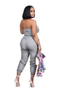 Detailed side view of women striped strapless jumpsuit with waist tie and cuffed hem