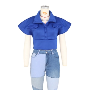 Detailed view of women's dark blue cropped top with patchwork denim jeans on mannequin