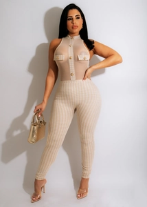 Detail of sheer mesh bodysuit with houndstooth print and decorative gold buttons