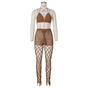 Detail view of handmade crochet beach set with hollow-out patterns and tassel hem in dark brown