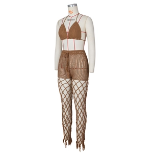 Detail of crochet beach set showing brown hollow-out fishnet pants and tassel drawstring
