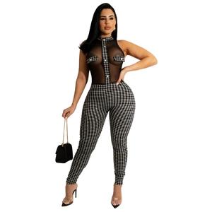 Detail of sheer mesh sleeveless bodice with houndstooth print jumpsuit and buttoned pockets