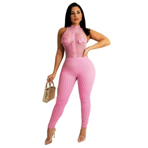 Detail of pink mesh halter top with gold buttons and houndstooth print jumpsuit