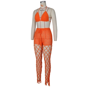 Detail of orange crochet three-piece beach set featuring hollow knit texture and bikini top