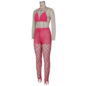 Detail of rose red crochet beach set showing drawstring waist and fringe hem on pants