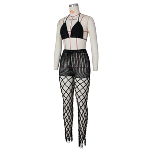 Detail of black crochet beach set featuring hollow mesh pattern and fringe hem decorations