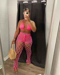 Detail of neon pink crochet three-piece set featuring bikini top and fishnet pants