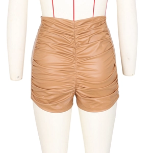 Detail view of the ruched back design on camel high-waist PU leather shorts for women
