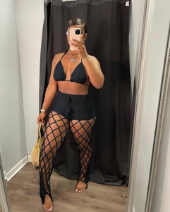 Detailed view of black crochet three-piece swimsuit with hollow mesh pants set
