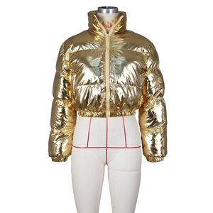 Detail of metallic gold cropped puffer jacket with stand collar and shiny mirror finish