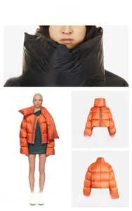 Detail of minimalist padded jacket with high collar and puffer texture in black and orange