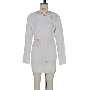 Detail view of white long-sleeve knit dress featuring ladder cut-outs and distressed texture