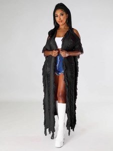 Détail d'un long gilet en maille noire avec texture ajourée et effet de franges