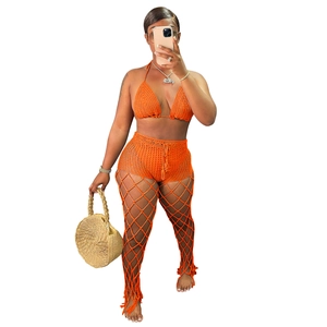 Three-piece orange crochet beach set featuring hollow knit bikini top and mesh pants
