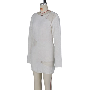 Close-up of white long sleeve knit dress featuring a unique cutout openwork fabric texture