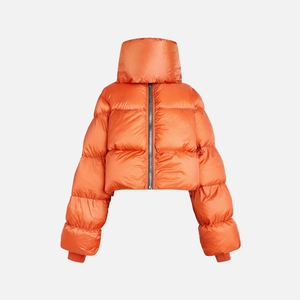 Close-up of bright orange puffer jacket featuring a thick stand-up collar and silver zipper
