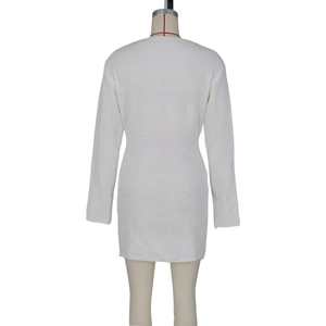 Back view of a white long sleeve knitted dress with a slim fit and textured fabric
