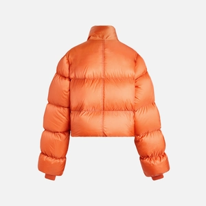 Back view of high-neck quilted puffer jacket in vibrant orange with ribbed knit cuffs