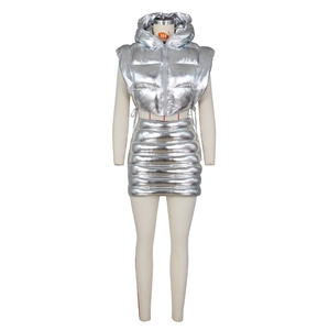 Detail of silver metallic hooded puffer vest and matching mini skirt on a white mannequin