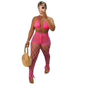 Detail of rose pink hand-crochet beach set with hollow-out knit pants and triangle bikini top