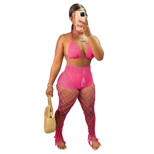 Detail of hot pink hand-crocheted three-piece set with mesh hollow-out beach trousers