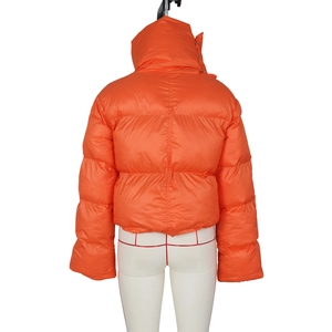 Rear view of bright orange puffer jacket with high collar and horizontal quilting detail