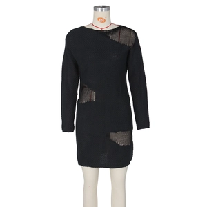 Detail of hollow-out knit dress with mesh splicing and distressed texture on black fabric