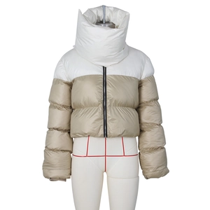 Detail of hooded scarf collar on two-tone cropped puffer jacket with black zipper