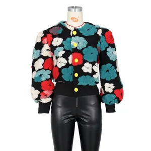 Detail of color-block fleece jacket with floral patterns and yellow buttons