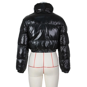 Detail of a shiny black cropped puffer jacket featuring a high stand collar and quilted design
