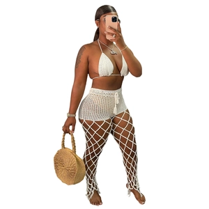 Detailed close-up of white crochet three-piece bikini set with sheer mesh hollow pattern
