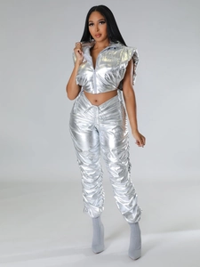 Detail of silver metallic two-piece set featuring hooded puffer vest and pleated pants