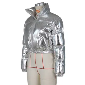 Detail of silver metallic puffer jacket showing reflective texture and horizontal quilting