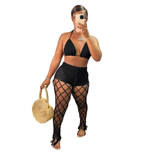 Detailed view of black 3-piece crochet beach set featuring hollow fishnet knit trousers