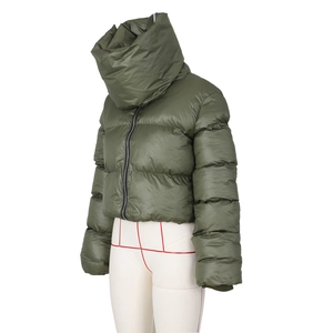 Detail of army green puffer jacket showing glossy quilted fabric and high collar design