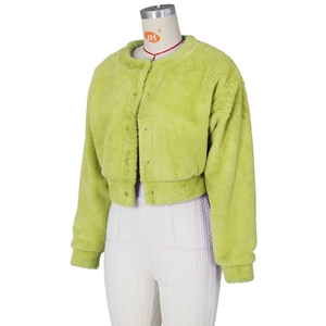 Detail of neon green faux fur jacket showing round buttons and plush texture on a mannequin