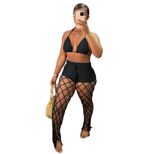 Detailed view of black crochet knit texture and mesh hollow pattern on three-piece beach set