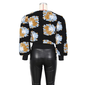 Detailed view of black vintage floral cardigan with blue embossed 3D cloud patterns