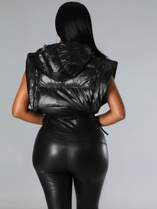 Detail view of glossy black padded vest back and faux leather leggings for women