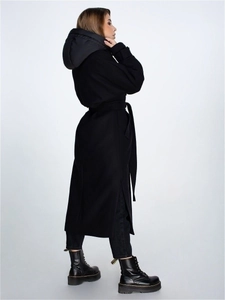 Vue détaillée du manteau long noir à capuche avec fentes latérales et ceinture assortie