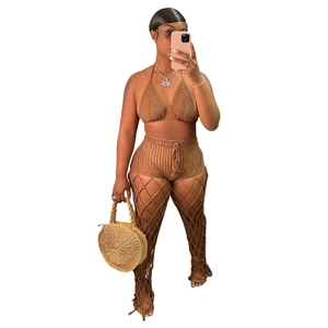 Detail of brown crochet halter bikini top and wide mesh knit pants for beachwear