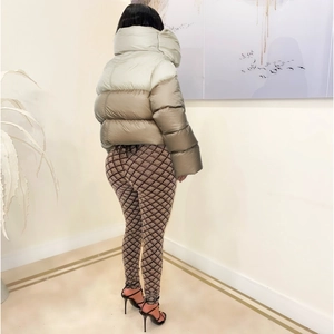 Rear view of quilted winter jacket featuring high collar and stylish two-tone color block