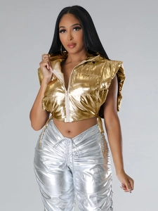 Close-up of metallic gold hooded puffer vest paired with shiny silver drawstring pants