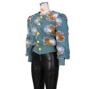 Detailed close-up of retro 3D floral tufting on the blue cardigan sleeve texture