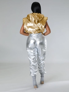 Rear view of gold metallic hooded puffer vest and silver pleated pants for women