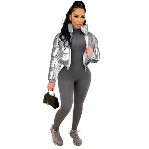 Detail of silver metallic puffer jacket and grey ribbed knit jumpsuit on a model