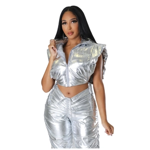 Detail of metallic silver hooded crop puffer vest and matching drawstring trousers set