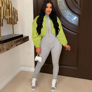 Detail of neon green faux fur cropped jacket paired with grey knit bodysuit