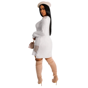 Detail view of white knitted mini dress featuring delicate mesh cutout on the sleeve and hem