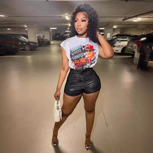 Women's high-waisted black pleated shorts with drawstring and white graphic t-shirt outfit